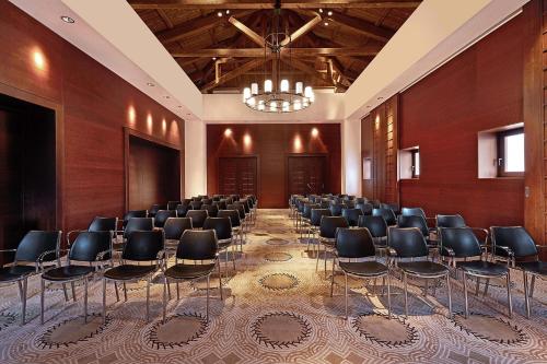 a room with a bunch of chairs in it at The Westin Resort, Costa Navarino in Romanós