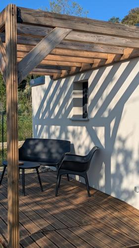a black bench sitting on a wooden deck at U Pagliaghju in Rutali