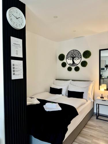 a bedroom with a bed with a clock on the wall at Secret Collection in Frauenkirchen