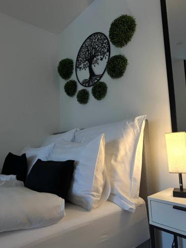 a bedroom with a bed with a tree on the wall at Secret Collection in Frauenkirchen