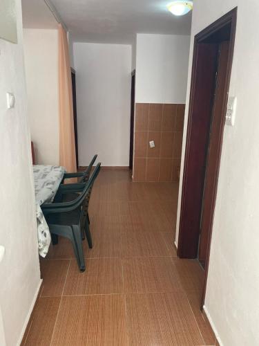 a room with two chairs and a table and a hallway at New house in Dobra Voda