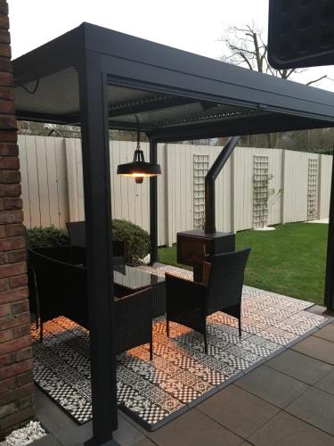 a pavilion with chairs and a table and a piano at Lady Hill, Royal Hillsborough in Hillsborough