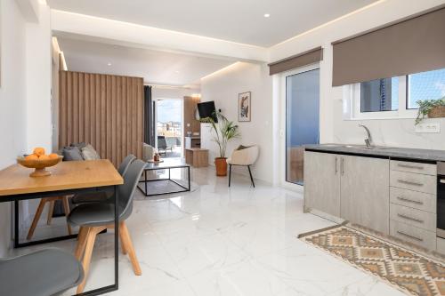 a kitchen and living room with a table and chairs at Anele Luxury Suites - Roof Top Jacuzzi in Chania Town