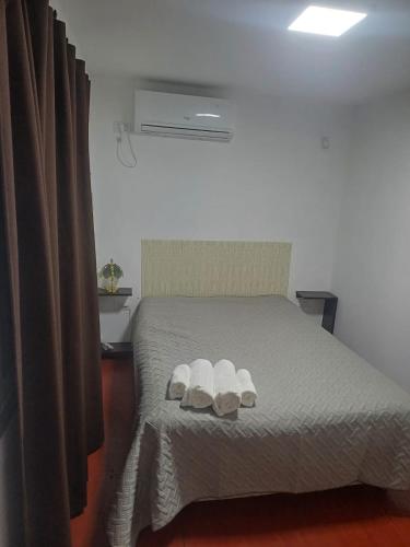 a bedroom with a bed with two towels on it at Con Armonia in Santa Rosa