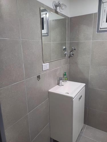 a bathroom with a white sink and a mirror at Con Armonia in Santa Rosa