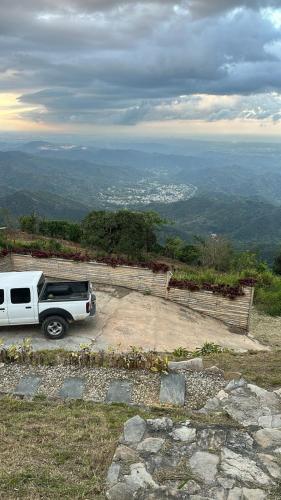 a white truck parked on top of a hill at Tiny House in the Mountains in San Cristóbal