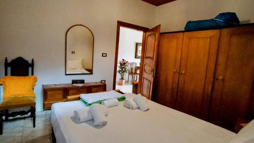 a bedroom with two beds and a mirror at The Home of Diplomacy in Gjirokastër