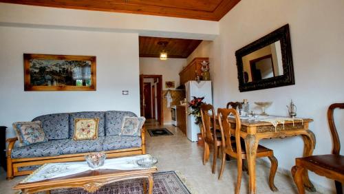 a living room with a couch and a table at The Home of Diplomacy in Gjirokastër