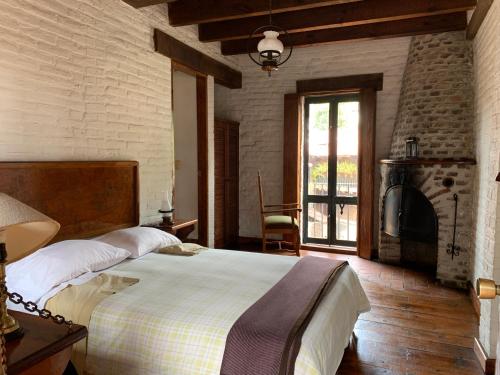 a bedroom with a large bed and a fireplace at Club de Vela Santa María in Valle de Bravo