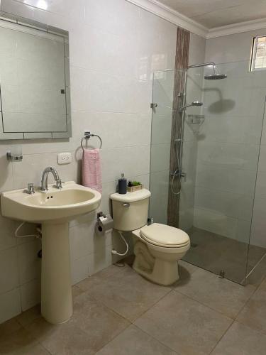 a bathroom with a toilet and a sink and a shower at Casa Estela in Cartagena de Indias