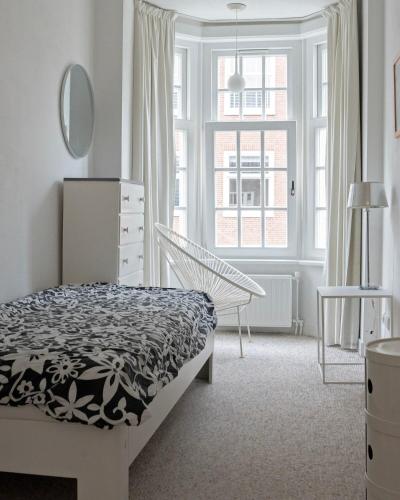a bedroom with a bed and a window at Authentic Amsterdam Apartment RAI in Amsterdam