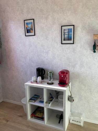 a white cabinet with a red appliance on a wall at Casa Hasselholt in Ratzeburg