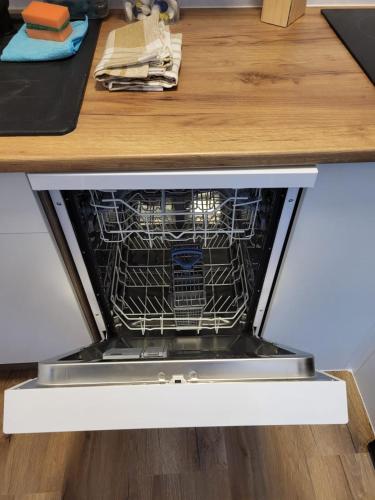 a dishwasher in a kitchen drawer with its door open at Hotel Essen 32 1-Zimmer Apartment in Essen