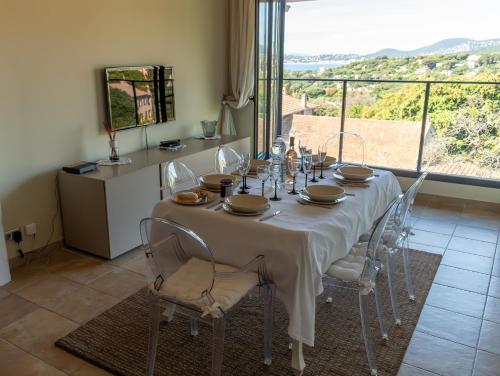 - une salle à manger avec une table et des chaises offrant une vue dans l'établissement Favoloso appartamento vista panoramica mare e colline, à La Croix-Valmer