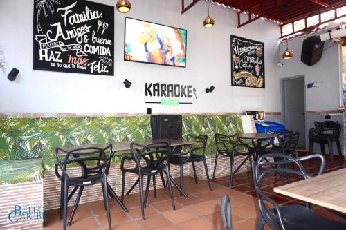 a group of tables and chairs in a restaurant at Hotel Bello Caribe Rodadero in Santa Marta
