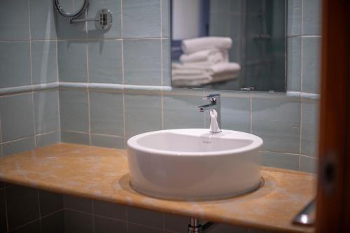 a bathroom with a white sink and a mirror at Hotel La Grava in El Morell