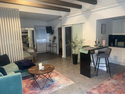a living room with a couch and a table at Secret Garden Vendégház in Pécs