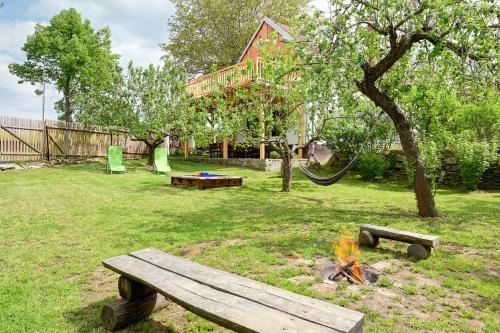 a park with a bench and a camp fire at Chalupa Ořešák - Walnut House in Svojšice