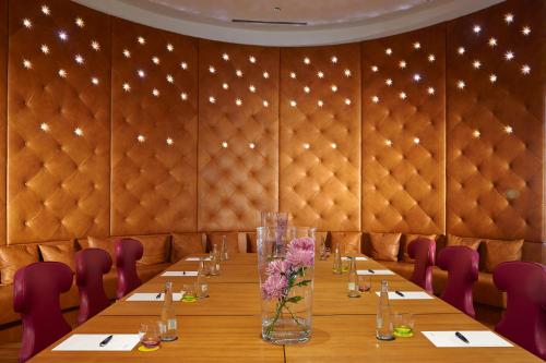 a conference room with a long table and purple chairs at Bohemia Suites & Spa - Adults Only in Playa del Ingles