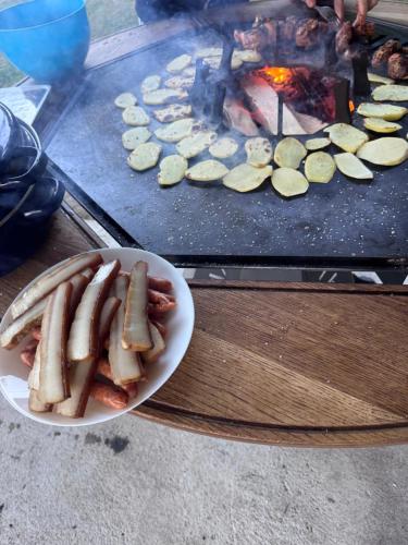 a plate of hot dogs and cucumbers on a grill at Vila Eliza Voronet in Voronet