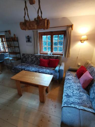 a living room with a couch and a coffee table at Chata Zuzanka - Tatranská Štrba v blízkosti Štrbské Pleso in Štrba