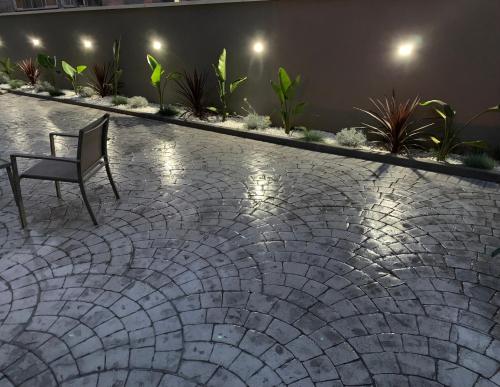 a chair sitting on a tile patio at night at Marconi B&B - Holiday Home in Marconia