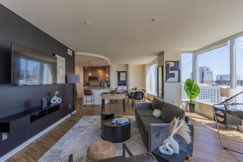 a living room with a couch and a table at Modern HighRise Sanctuary, Gym, Pool, Prking, W-D, Golf in Phoenix
