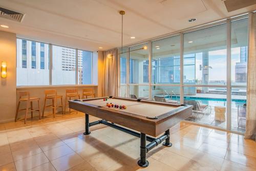 a pool table in a room with a swimming pool at Modern HighRise Sanctuary, Gym, Pool, Prking, W-D, Golf in Phoenix