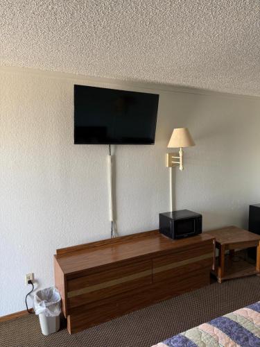 a flat screen tv on the wall of a hotel room at Royal Inn in Oklahoma City