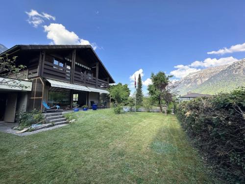 a house with a large yard in front of it at Chalet Rose - Einfamilienhaus in Interlaken