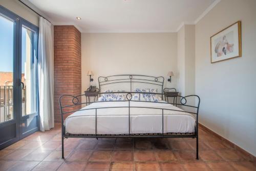 a bedroom with a bed in a room with a window at Hotel La Grava in El Morell