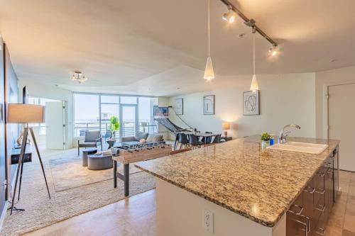 a kitchen and living room with a large counter top at Stunning 2BR DT HighRise, Gym, Pool, W-D, Parking, Golf in Phoenix
