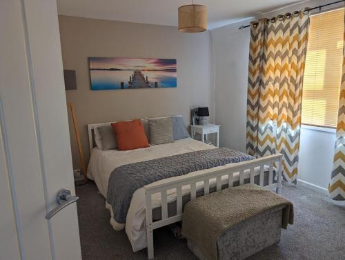 ein Schlafzimmer mit einem Bett und einem Fenster in der Unterkunft Family house near the beach! in Saint Columb Minor