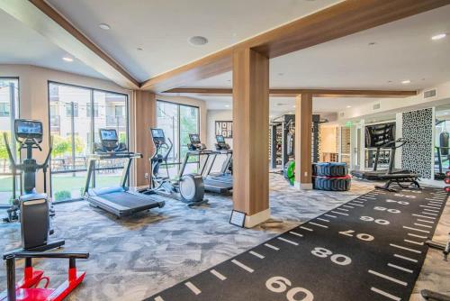 a gym with treadmills and elliptical machines at Quaint 2BR Uptown Biltmore Gym Pool Parking WD in Phoenix