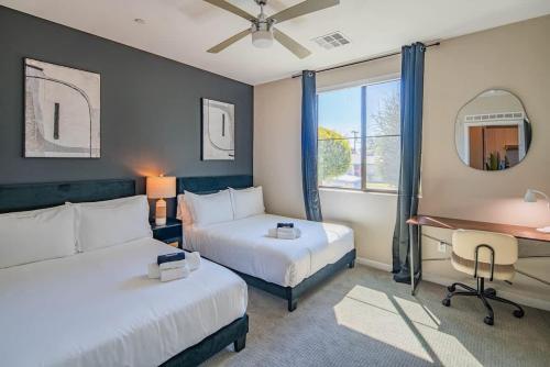 a hotel room with two beds and a desk at Quaint 2BR Uptown Biltmore Gym Pool Parking WD in Phoenix