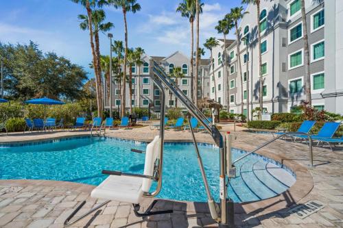 a swimming pool with a slide in front of a building at Lake Buenavista Apartments close to Disney in Orlando