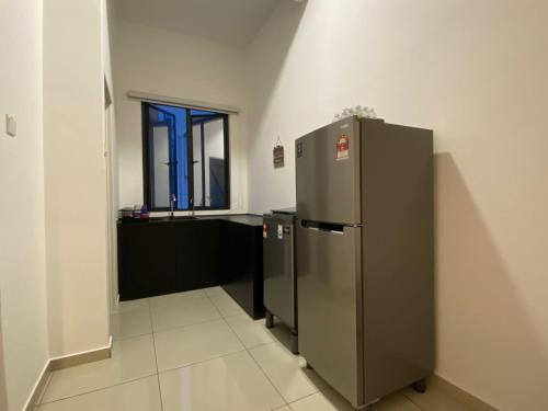 a kitchen with a stainless steel refrigerator and a window at WeStay Homestay 15-1 in Bukit Mertajam