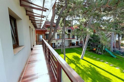 a balcony of a house with a yard at Royal Mediterran in Siófok