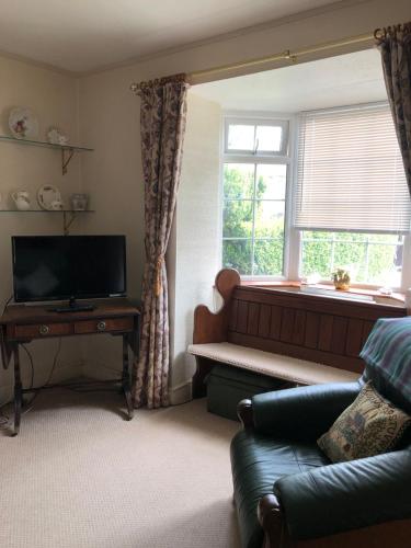 a living room with a couch and a window at Ryedale House in Sleights