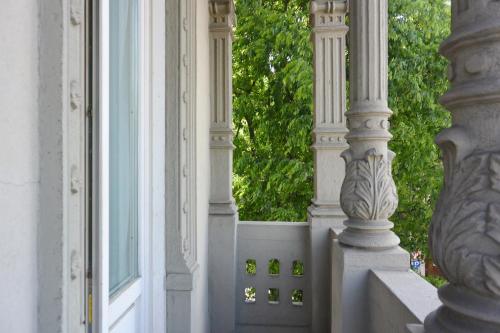 a white building with two columns and a window at Hotel Moderno in Pavia