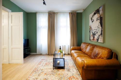 a living room with a brown leather couch at #Cozy Central Nest with Balcony in Timişoara