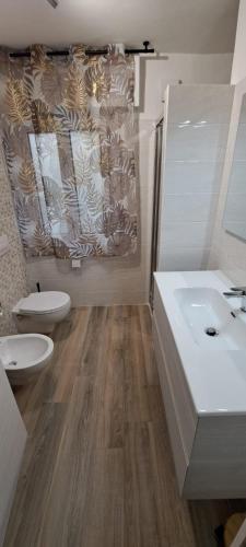 a bathroom with two toilets and a sink at Casa Mar in Francavilla al Mare
