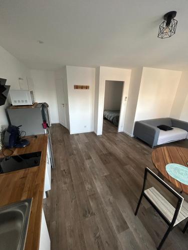 an empty living room with a bed and a table at Appartement T2 Saint Malo, Dinard, Dinan et Dol in Miniac-Morvan