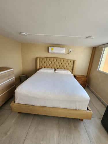 a bedroom with a large bed in a room at Hotel y Cabañas Covemar in Coveñas
