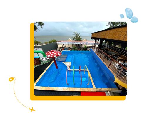 an empty swimming pool with an umbrella and an umbrella at Pousada Tapary Beach in Santarém