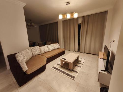 a living room with a couch and a table at Comfort Plaza Andalus in New cairo