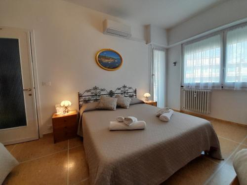 a bedroom with a bed with two towels on it at Sweet Lucy in Rapallo