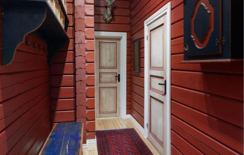 a red house with a door and a bench in a room at Amazing Home In Hovet With Sauna in Hovet