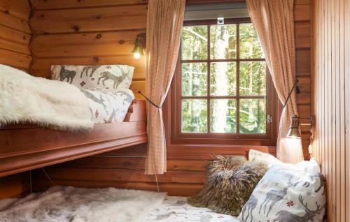 a room with a window in a log cabin at Amazing Home In Hovet With Sauna in Hovet