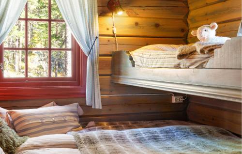 a room with two bunk beds in a log cabin at Amazing Home In Hovet With Sauna in Hovet